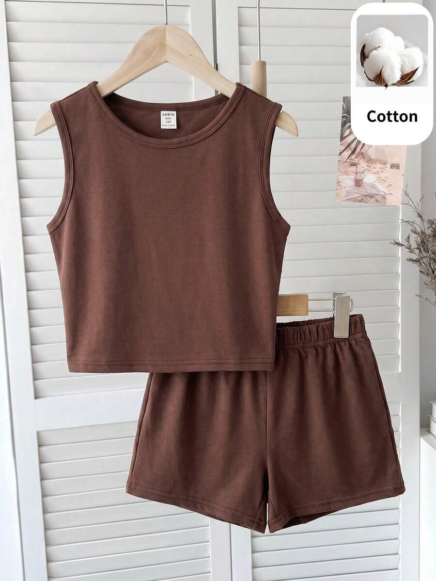 Tween girls black and white two-piece casual summer outfit featuring a rib-knit cropped top with round neck and matching shorts with contrast piping.