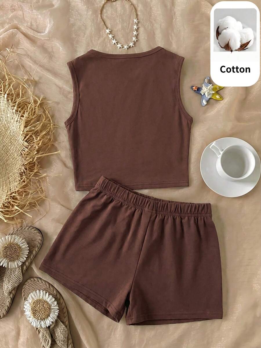 Tween girls black and white two-piece casual summer outfit featuring a rib-knit cropped top with round neck and matching shorts with contrast piping.