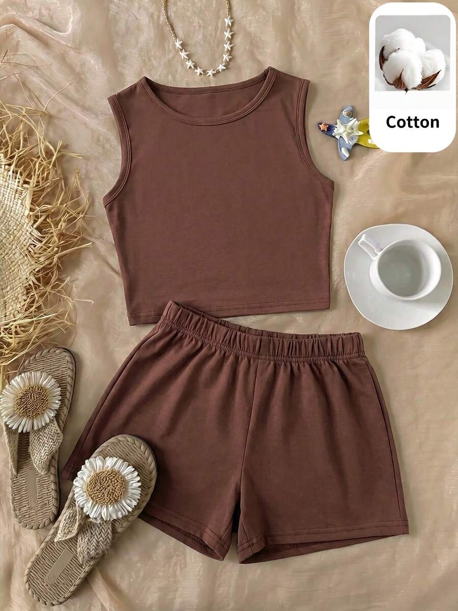 Tween girls black and white two-piece casual summer outfit featuring a rib-knit cropped top with round neck and matching shorts with contrast piping.