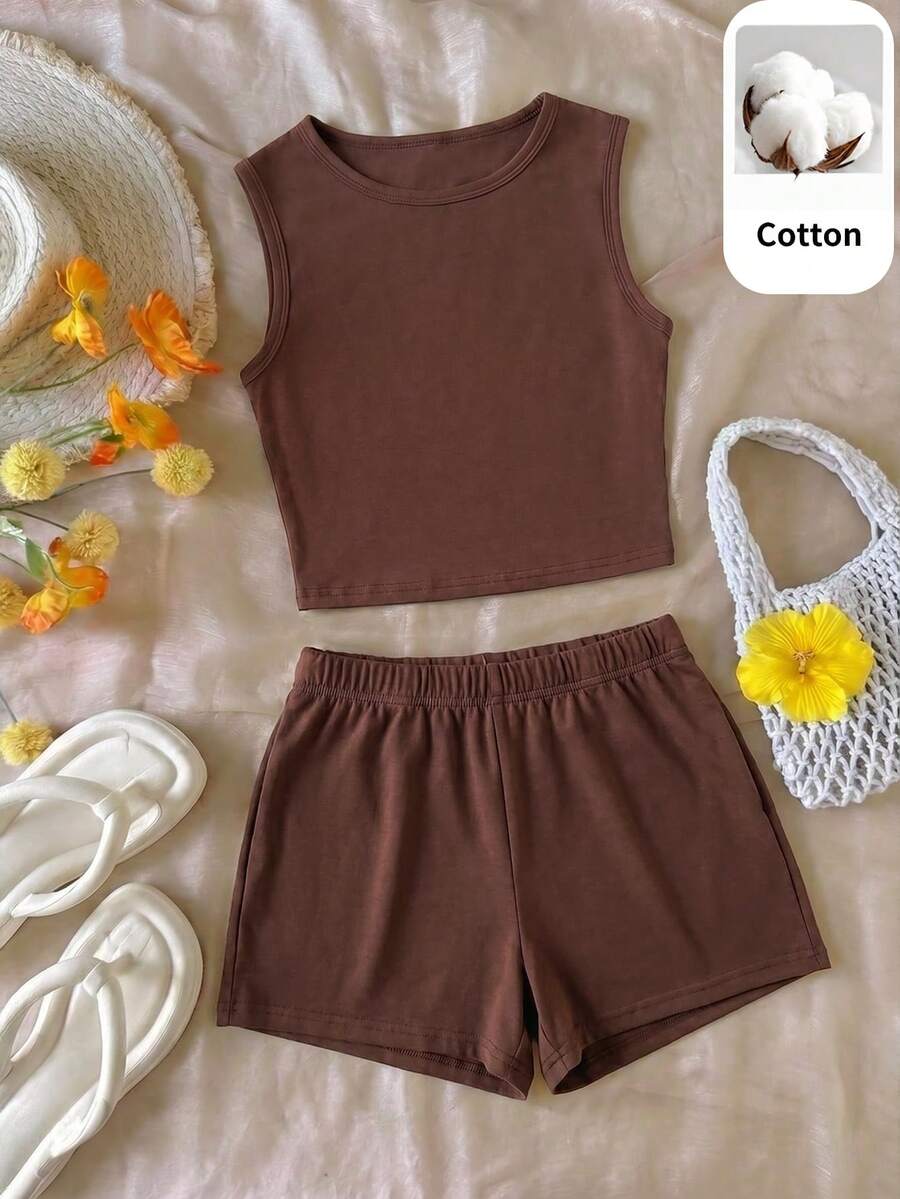 Tween girls black and white two-piece casual summer outfit featuring a rib-knit cropped top with round neck and matching shorts with contrast piping.