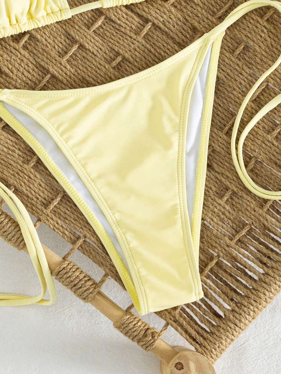 Women's striped halter bikini top with removable padding and matching tie-side low-waist swimsuit bottoms.