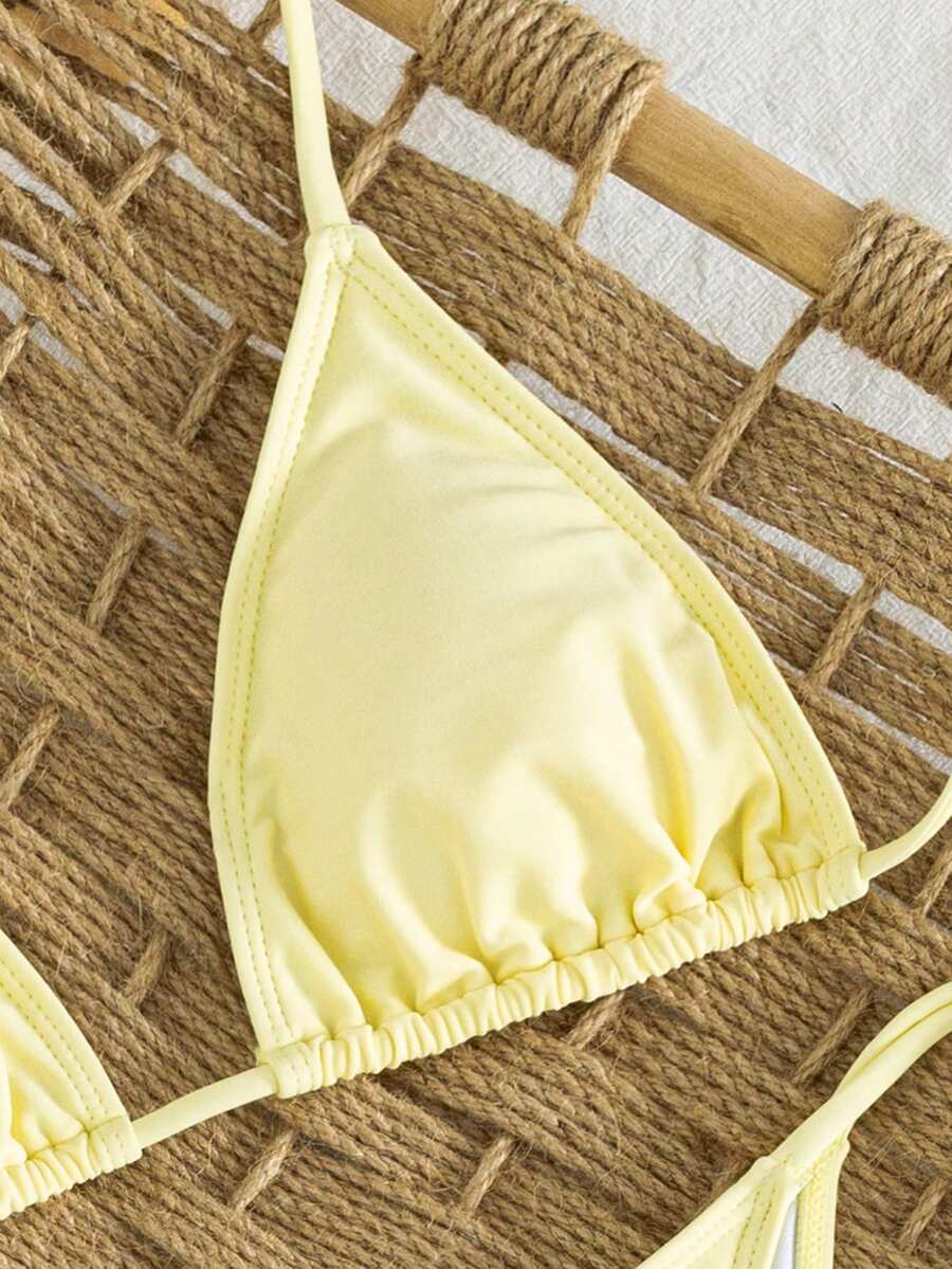 Women's striped halter bikini top with removable padding and matching tie-side low-waist swimsuit bottoms.