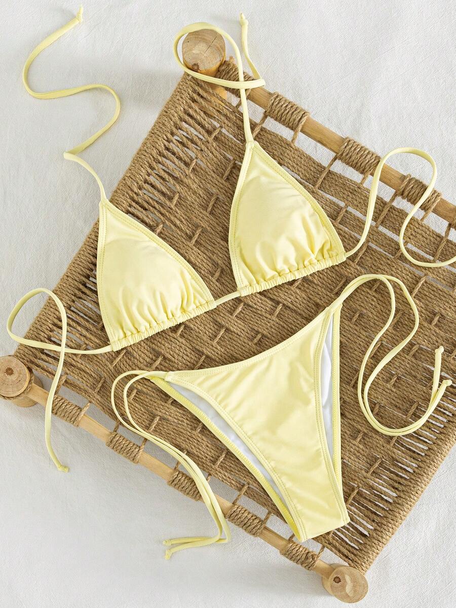 Women's striped halter bikini top with removable padding and matching tie-side low-waist swimsuit bottoms.