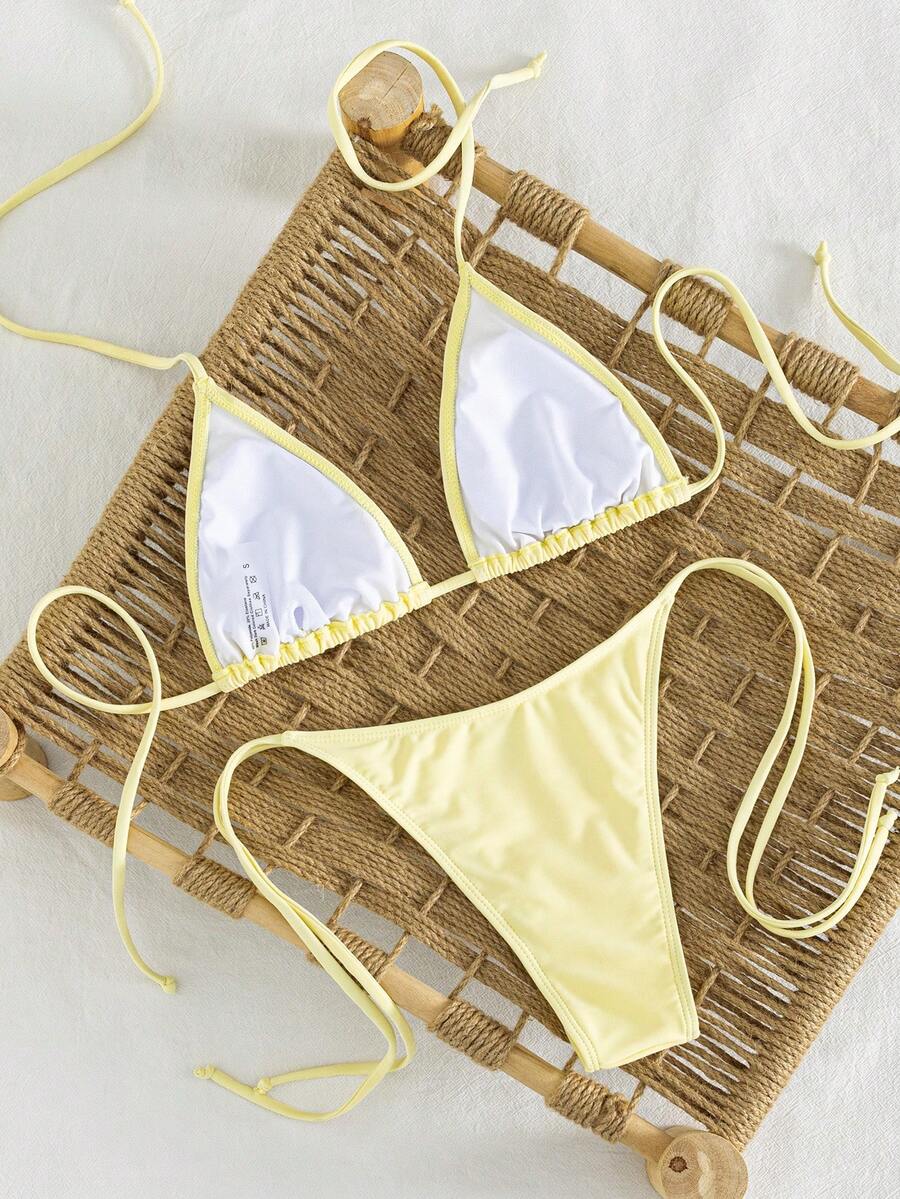 Women's striped halter bikini top with removable padding and matching tie-side low-waist swimsuit bottoms.