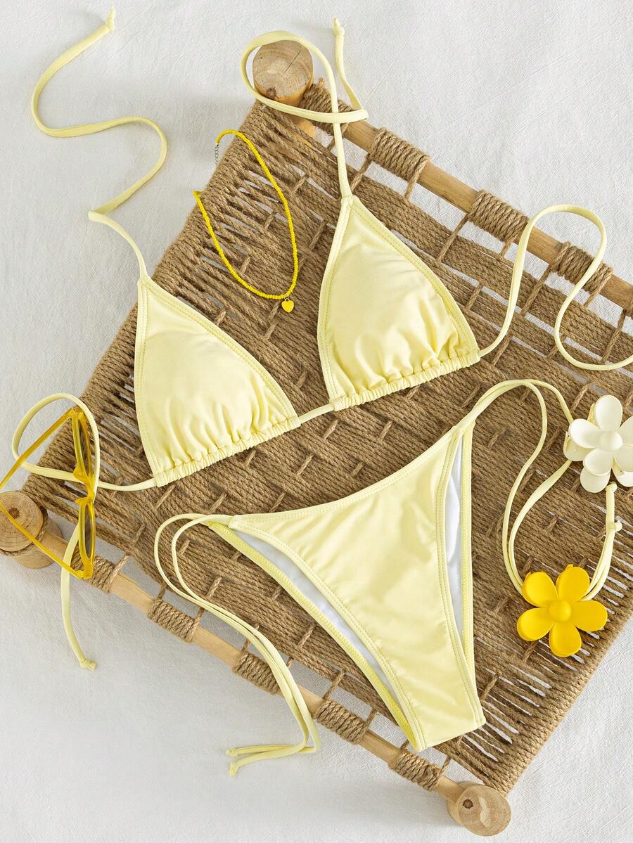 Women's striped halter bikini top with removable padding and matching tie-side low-waist swimsuit bottoms.