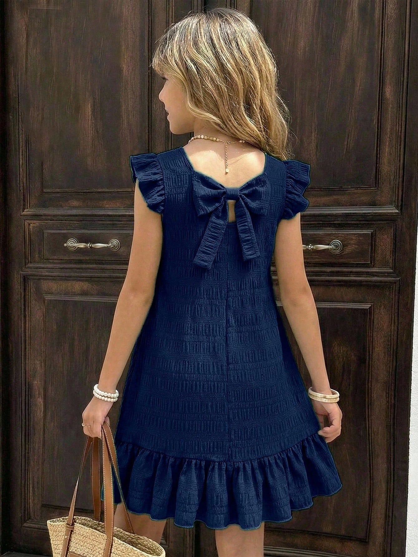 Tween girls apricot vacation midi dress featuring a round neck, cut out details, ruffle flounce accents, and geometric pattern.