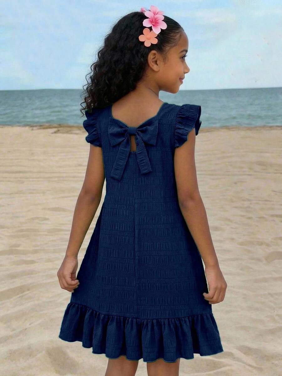 Tween girls apricot vacation midi dress featuring a round neck, cut out details, ruffle flounce accents, and geometric pattern.