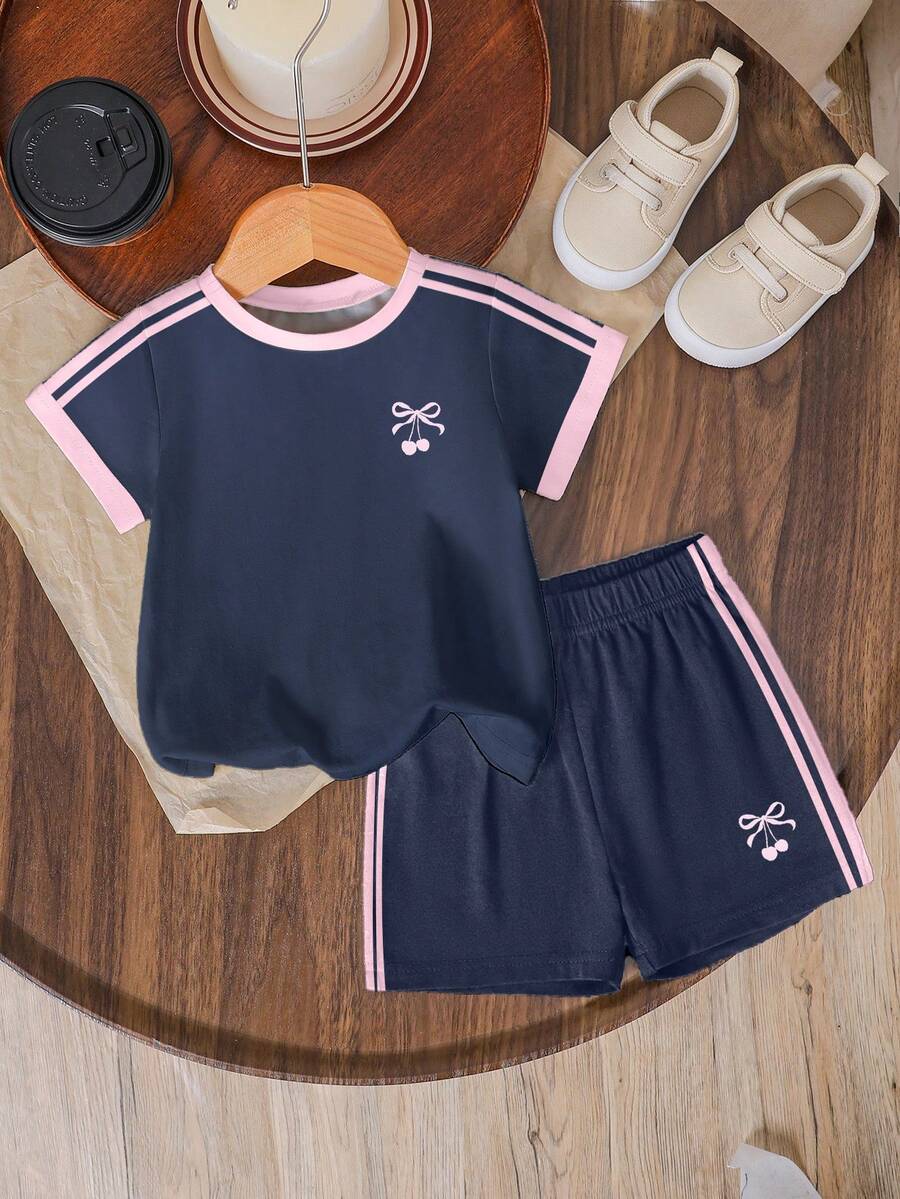 Tween girls two-piece green summer outfit featuring a fruit print short sleeve round neck t-shirt and matching track shorts with pockets.