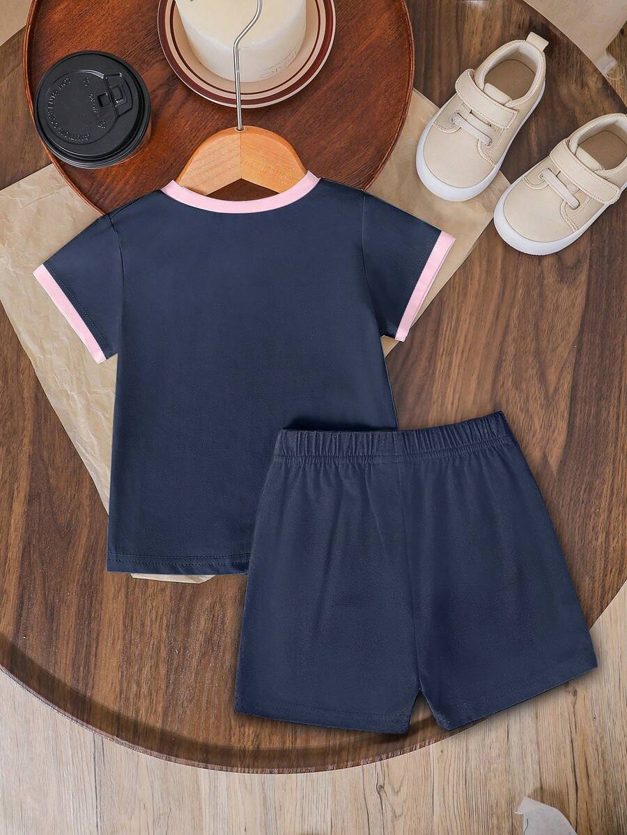 Tween girls two-piece green summer outfit featuring a fruit print short sleeve round neck t-shirt and matching track shorts with pockets.