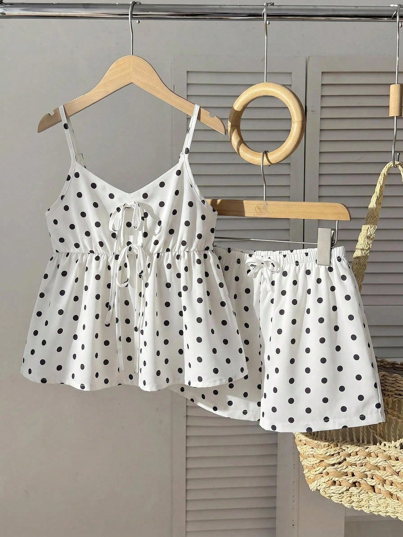 Tween girl 2-piece summer set with a black and white sleeveless striped spaghetti strap tank top with ruffle details and matching casual shorts.