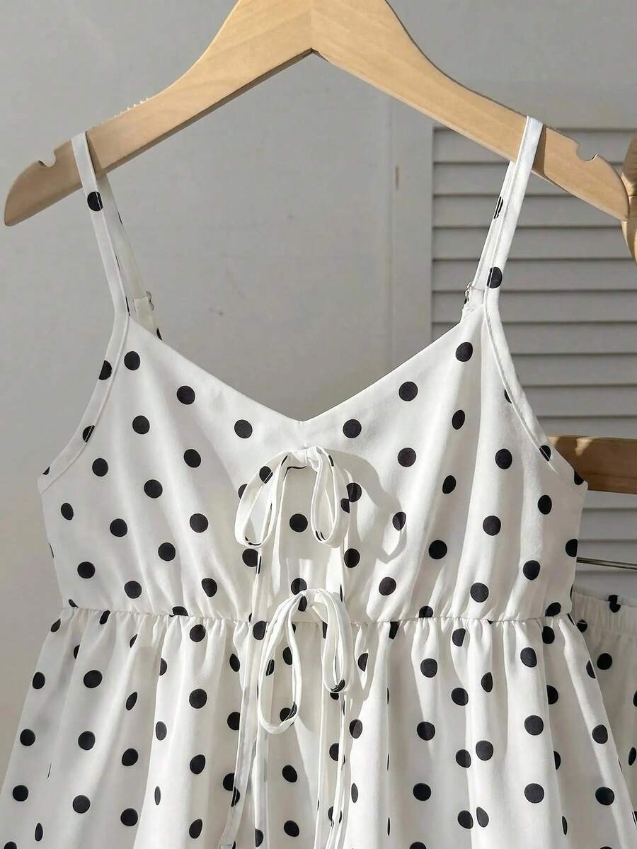 Tween girl 2-piece summer set with a black and white sleeveless striped spaghetti strap tank top with ruffle details and matching casual shorts.