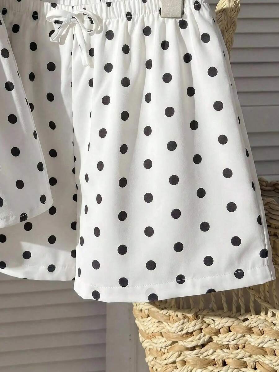 Tween girl 2-piece summer set with a black and white sleeveless striped spaghetti strap tank top with ruffle details and matching casual shorts.