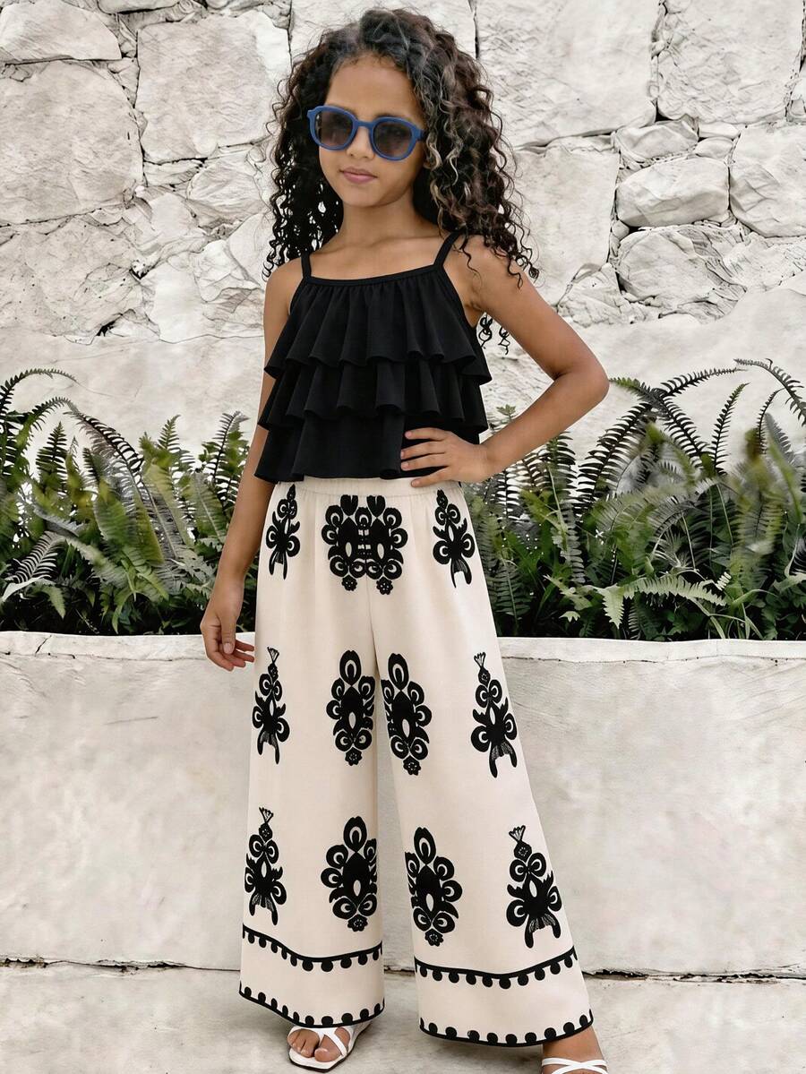 Tween girls blue 2-piece vacation outfit set featuring a tiered ruffle spaghetti strap camisole and loose high-waist pants.