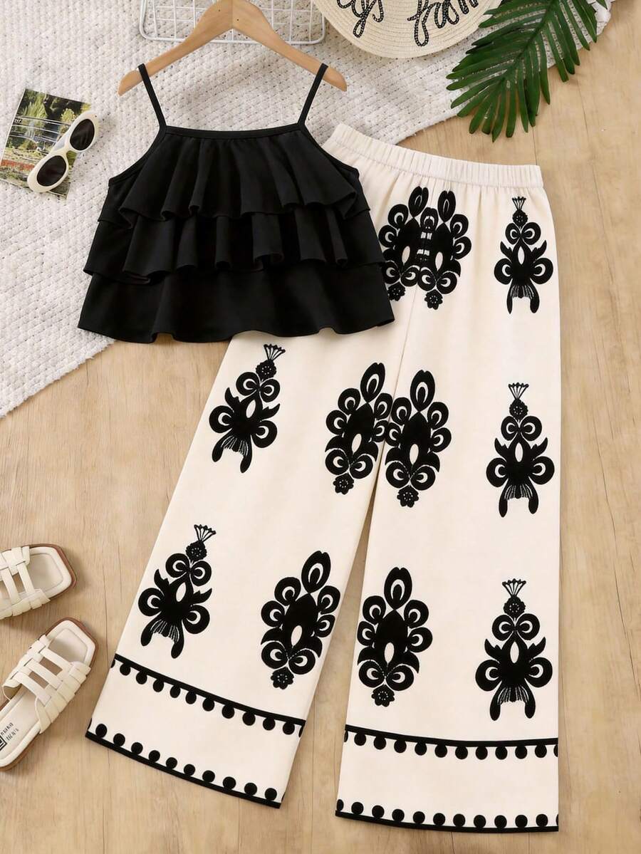 Tween girls blue 2-piece vacation outfit set featuring a tiered ruffle spaghetti strap camisole and loose high-waist pants.