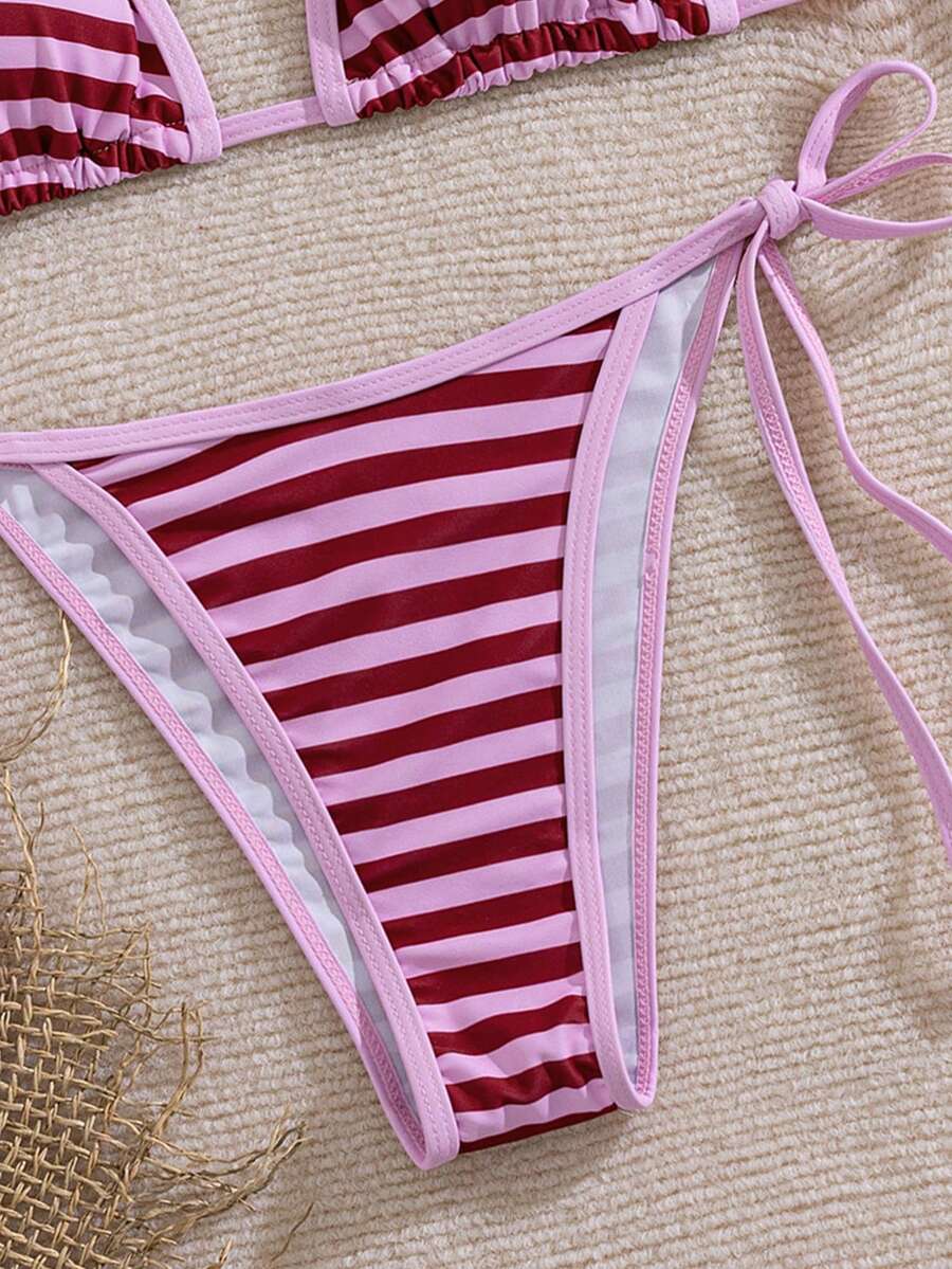 Women's two-piece halter triangle bikini set featuring a backless tie-back top with removable padding and matching tie-side mid-waist bottoms.