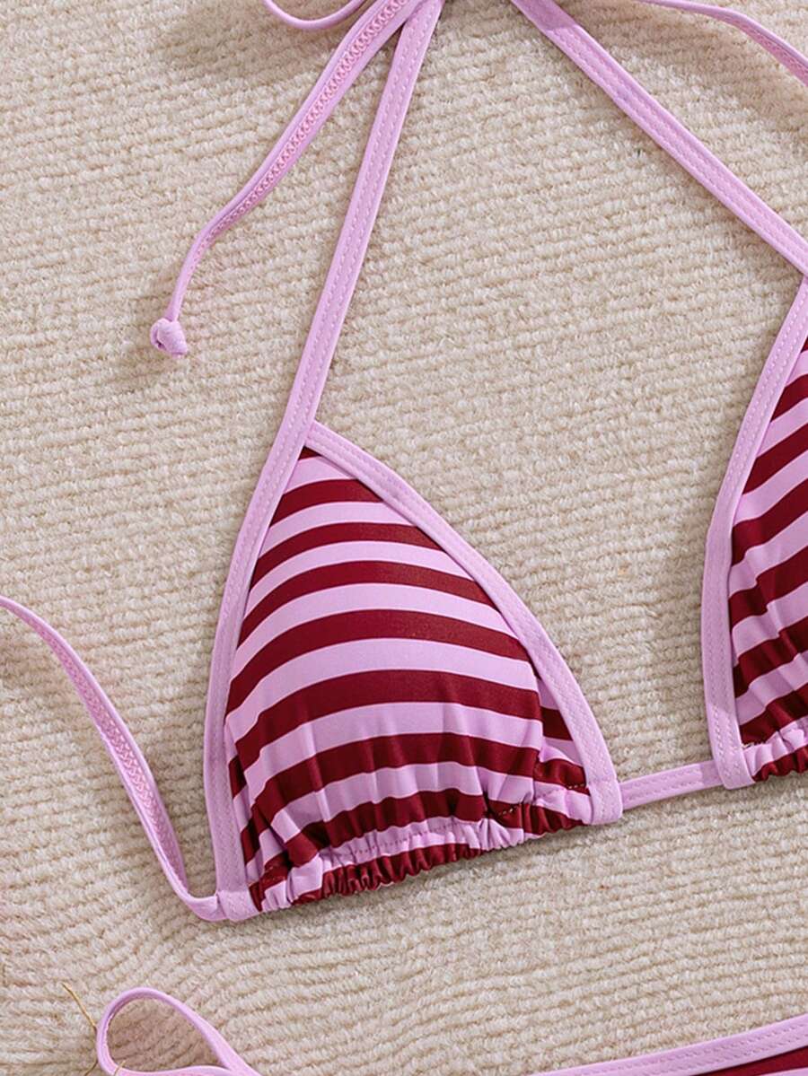 Women's two-piece halter triangle bikini set featuring a backless tie-back top with removable padding and matching tie-side mid-waist bottoms.