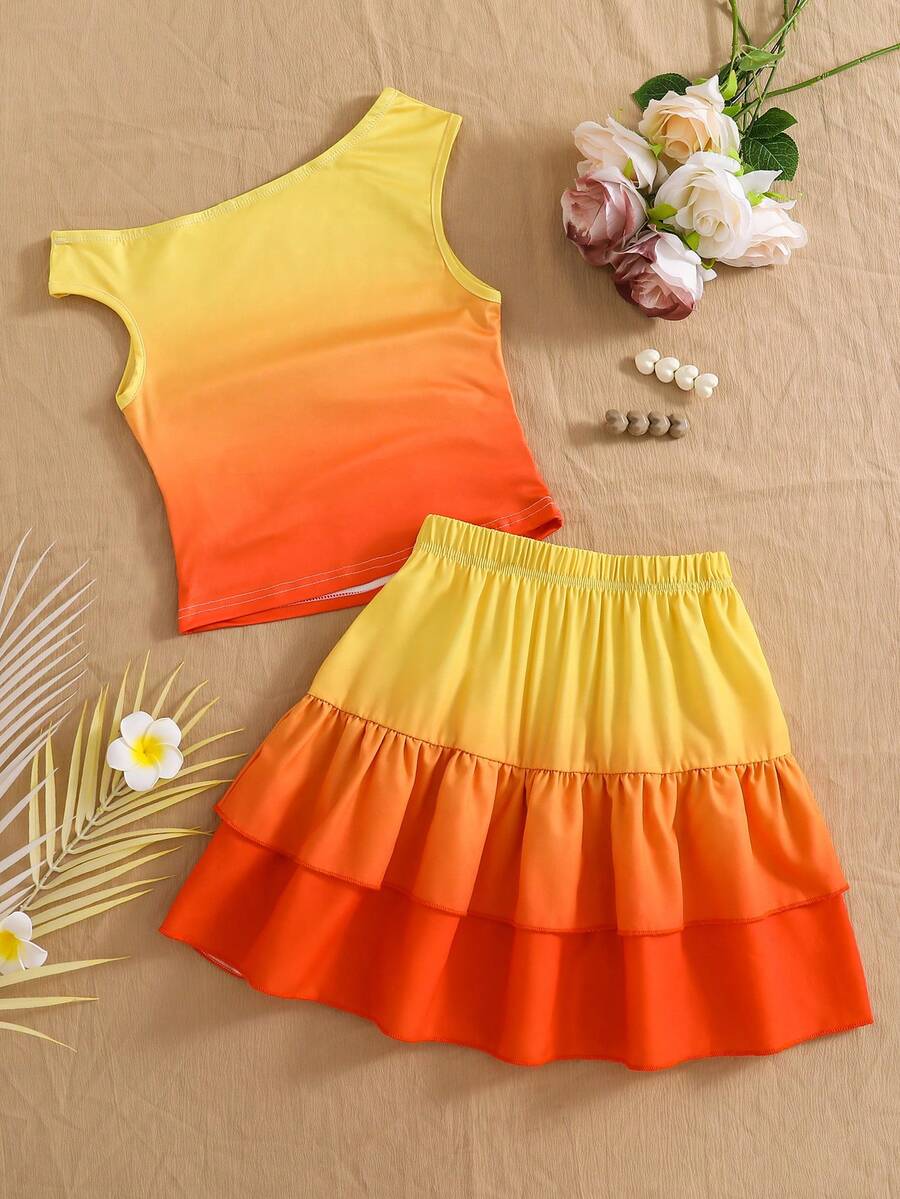 Light blue two-piece outfit set for tween girls with a sleeveless round neck vest top and a tiered ruffle cake skirt featuring a plant pattern.