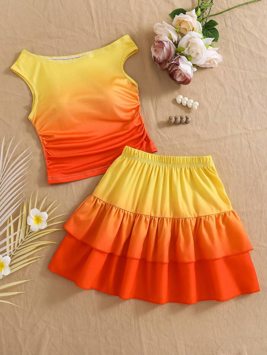 Light blue two-piece outfit set for tween girls with a sleeveless round neck vest top and a tiered ruffle cake skirt featuring a plant pattern.