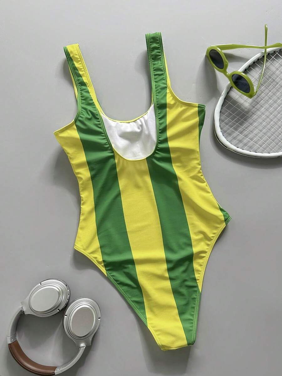 Women's solid color one-piece swimsuit featuring a backless scoop neck design and high cut fit
