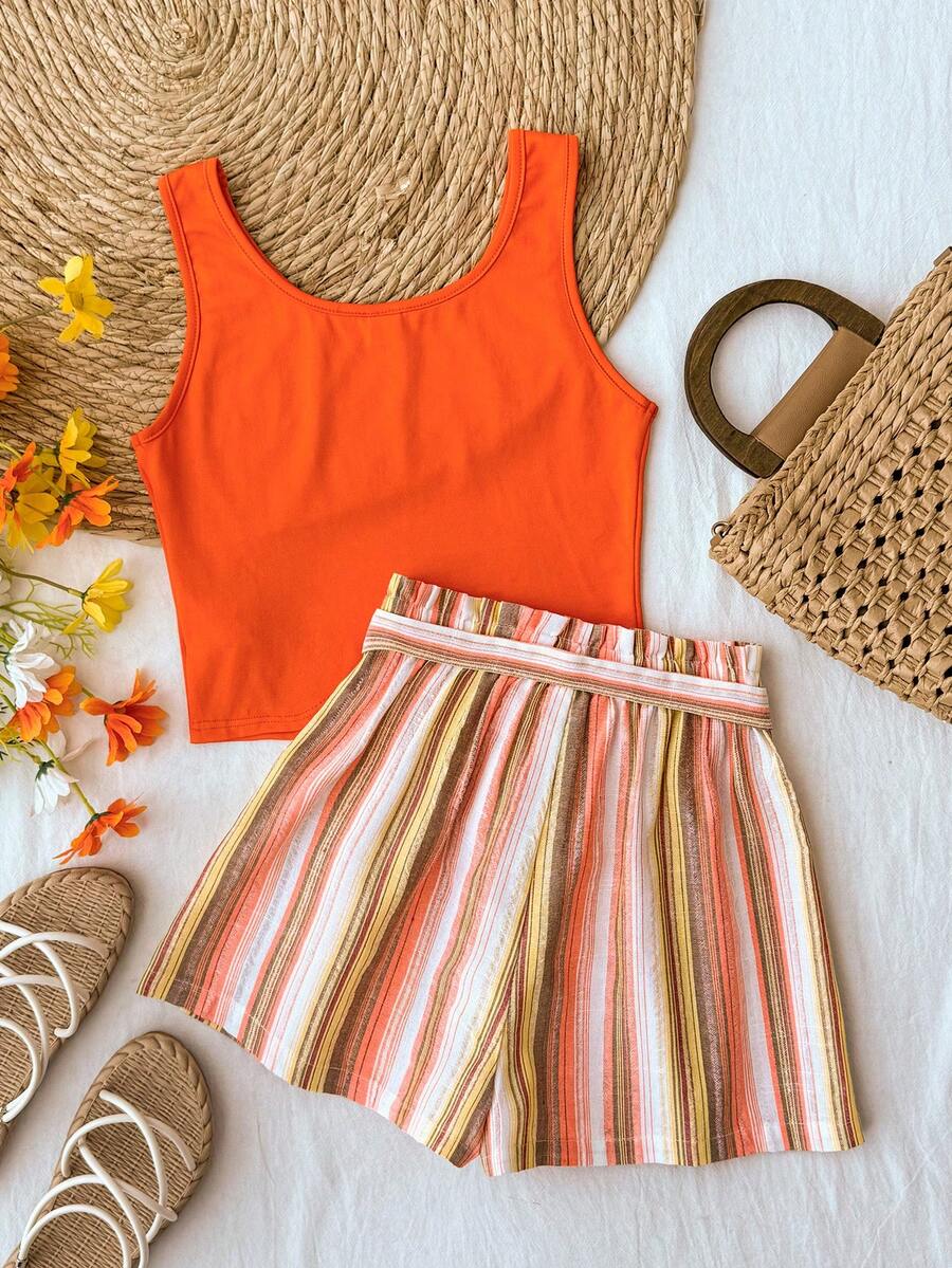 Tween girl summer two-piece outfit featuring a white scoop neck tank top and green ditsy floral print paperbag waist shorts with belt.