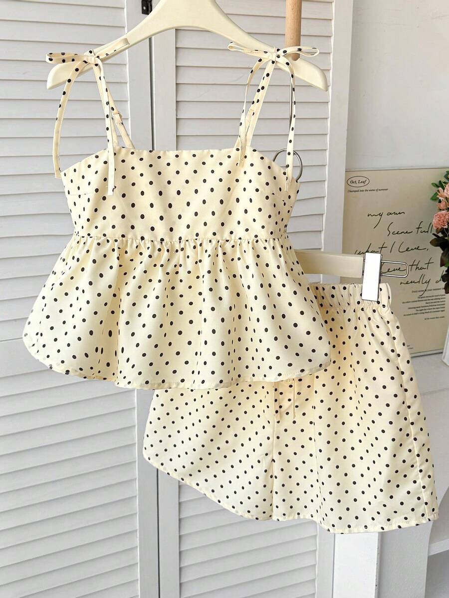 Tween girl 2-piece summer set with a black and white sleeveless striped spaghetti strap tank top with ruffle details and matching casual shorts.