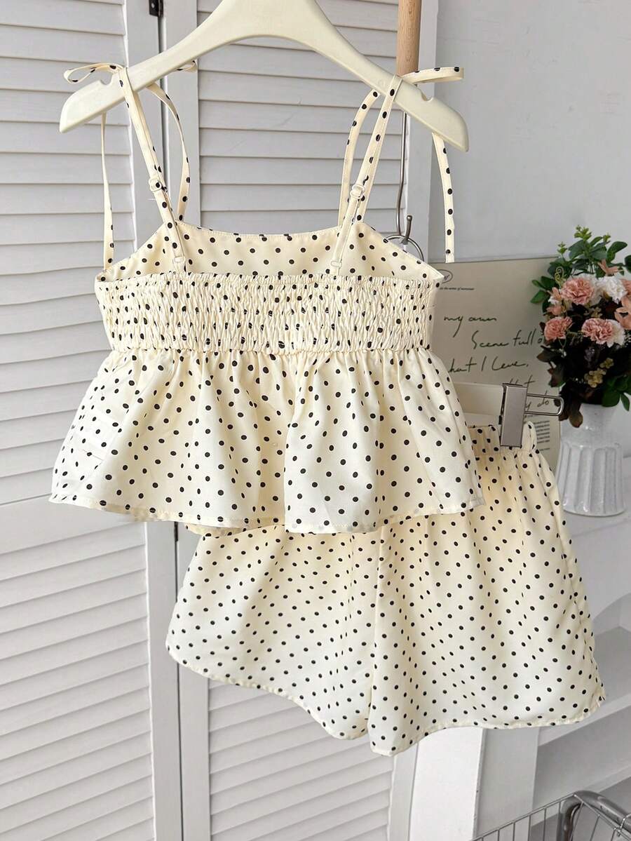 Tween girl 2-piece summer set with a black and white sleeveless striped spaghetti strap tank top with ruffle details and matching casual shorts.