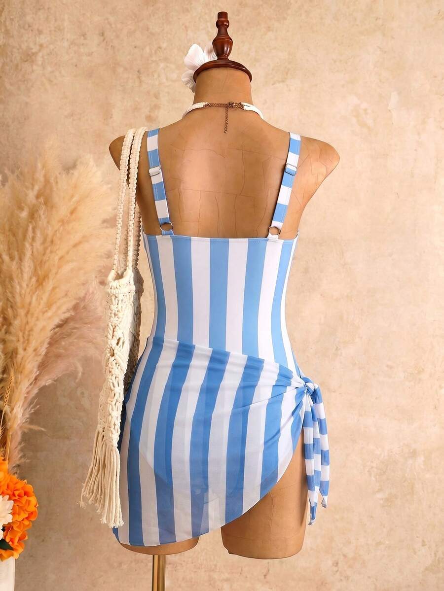 Women's black floral print plunge neck one-piece swimsuit featuring cut-out detail paired with a matching knee-length mesh cover-up skirt