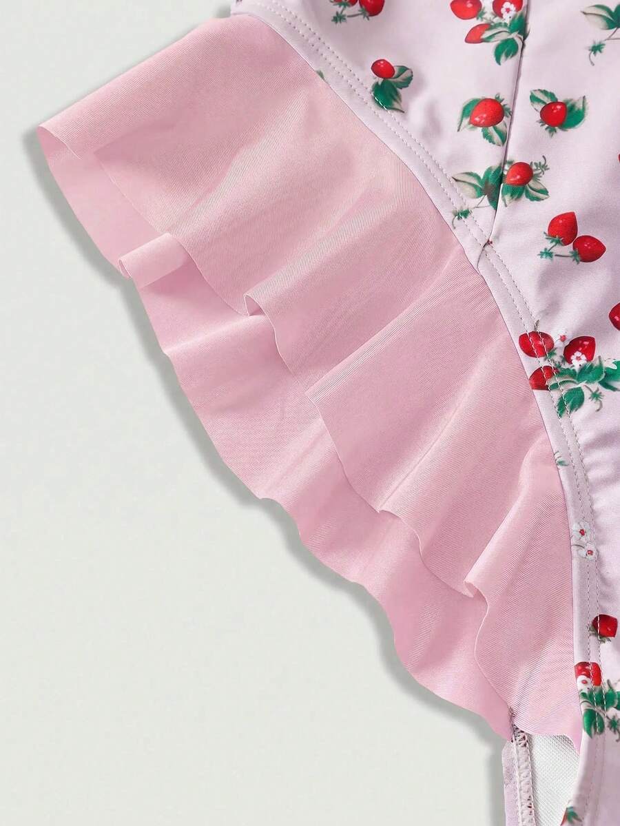 Women's strawberry print one-piece swimsuit featuring ruffle details, front-tie design, backless criss-cross straps, and triangle wireless cups.