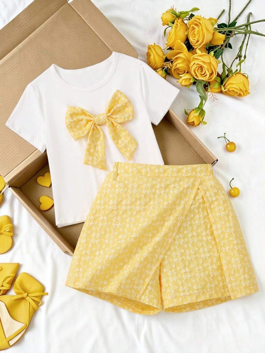 Tween girls 2-piece blue outfit featuring a short sleeve round neck t-shirt with a bow front detail and an asymmetric wrap skort.