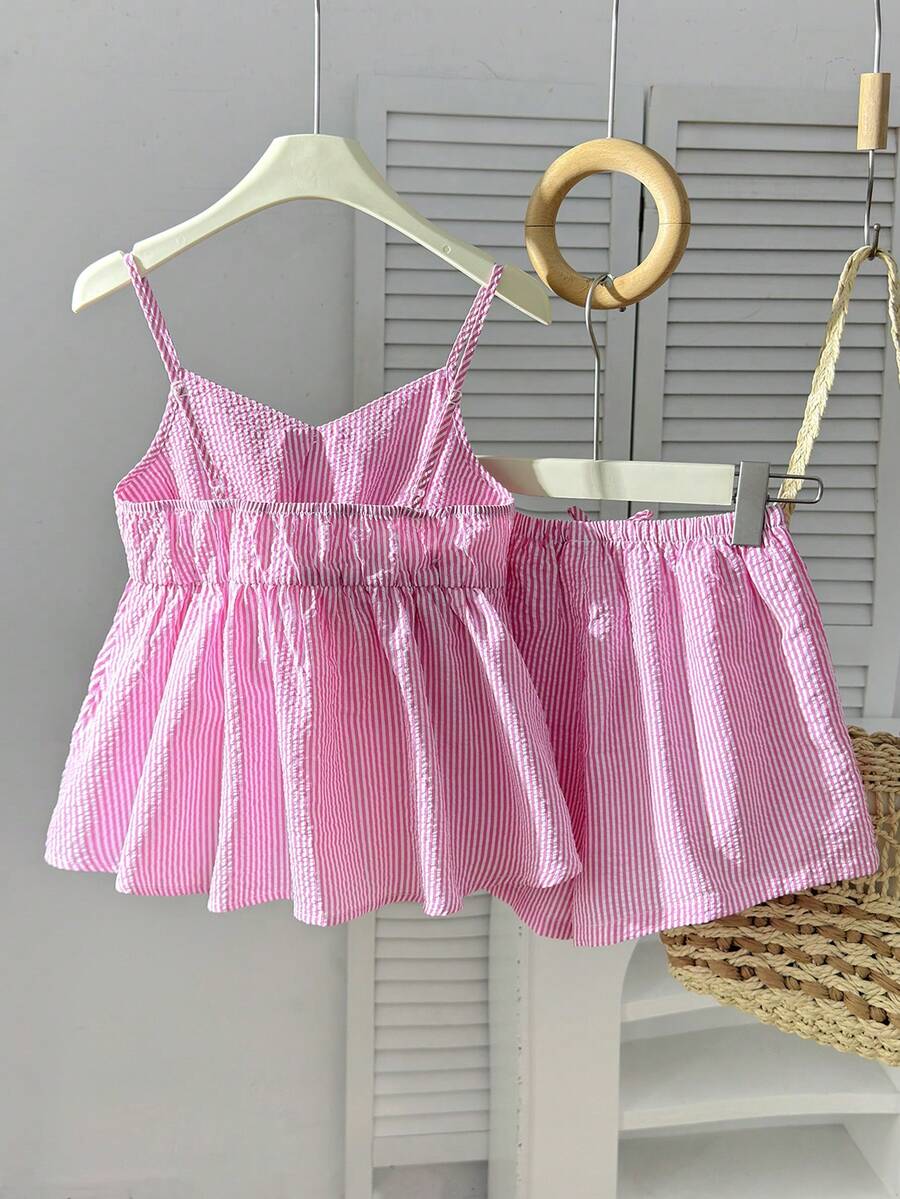Tween girl 2-piece summer set with a black and white sleeveless striped spaghetti strap tank top with ruffle details and matching casual shorts.