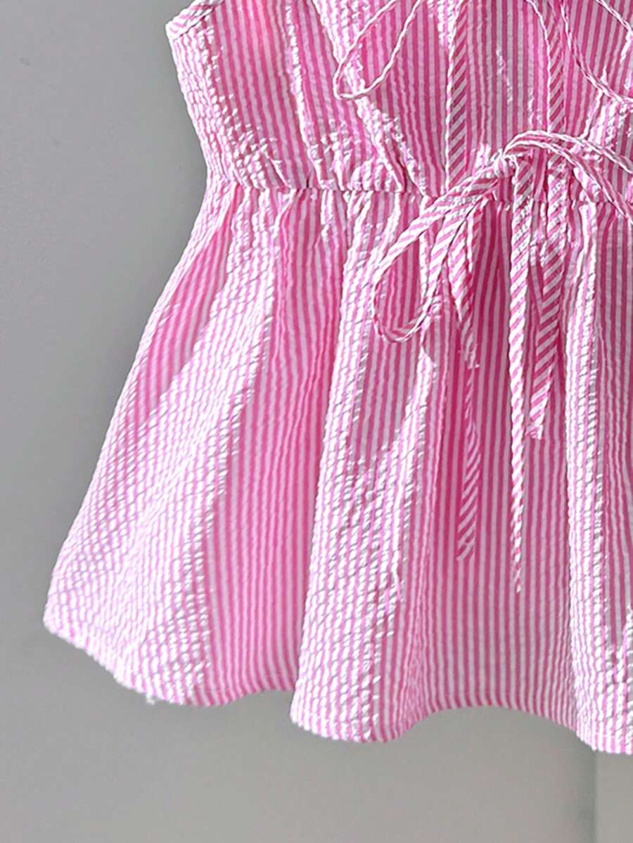 Tween girl 2-piece summer set with a black and white sleeveless striped spaghetti strap tank top with ruffle details and matching casual shorts.