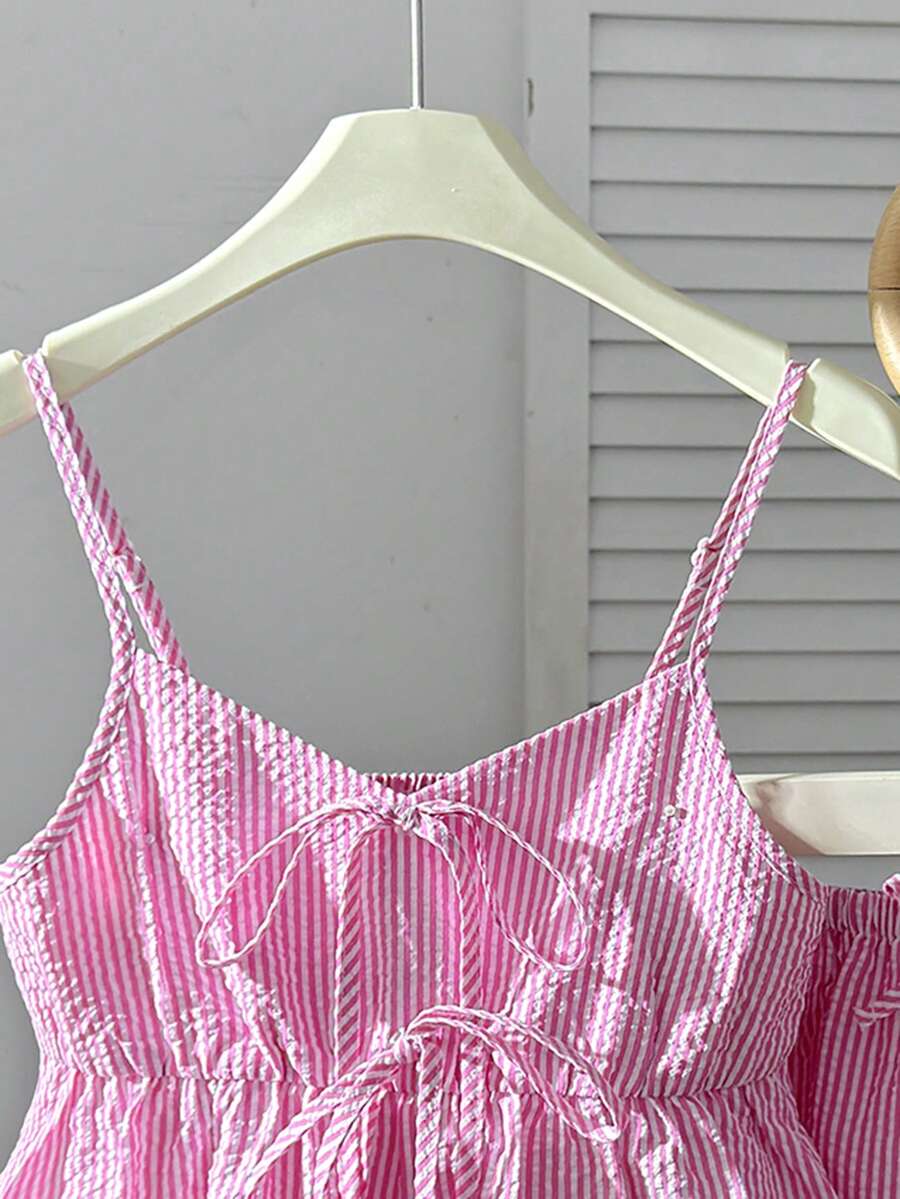 Tween girl 2-piece summer set with a black and white sleeveless striped spaghetti strap tank top with ruffle details and matching casual shorts.
