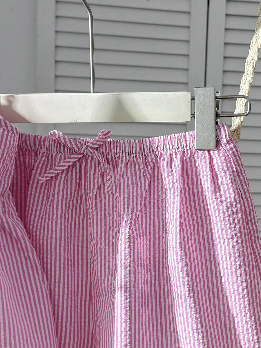 Tween girl 2-piece summer set with a black and white sleeveless striped spaghetti strap tank top with ruffle details and matching casual shorts.