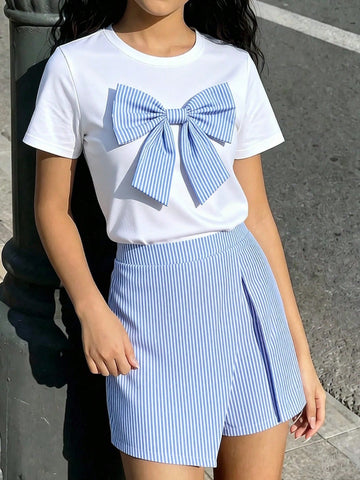 Tween girls 2-piece blue outfit featuring a short sleeve round neck t-shirt with a bow front detail and an asymmetric wrap skort.
