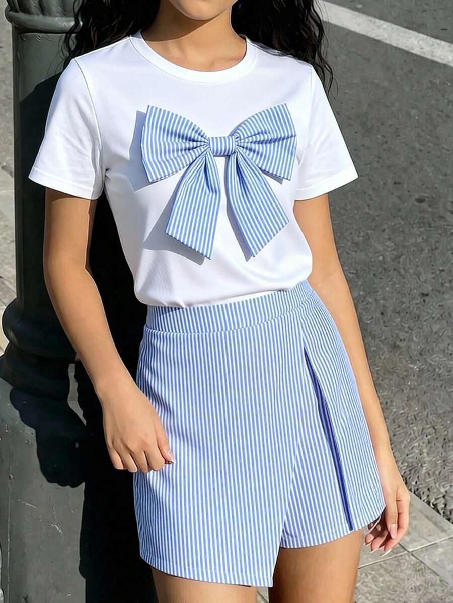 Tween girls 2-piece blue outfit featuring a short sleeve round neck t-shirt with a bow front detail and an asymmetric wrap skort.