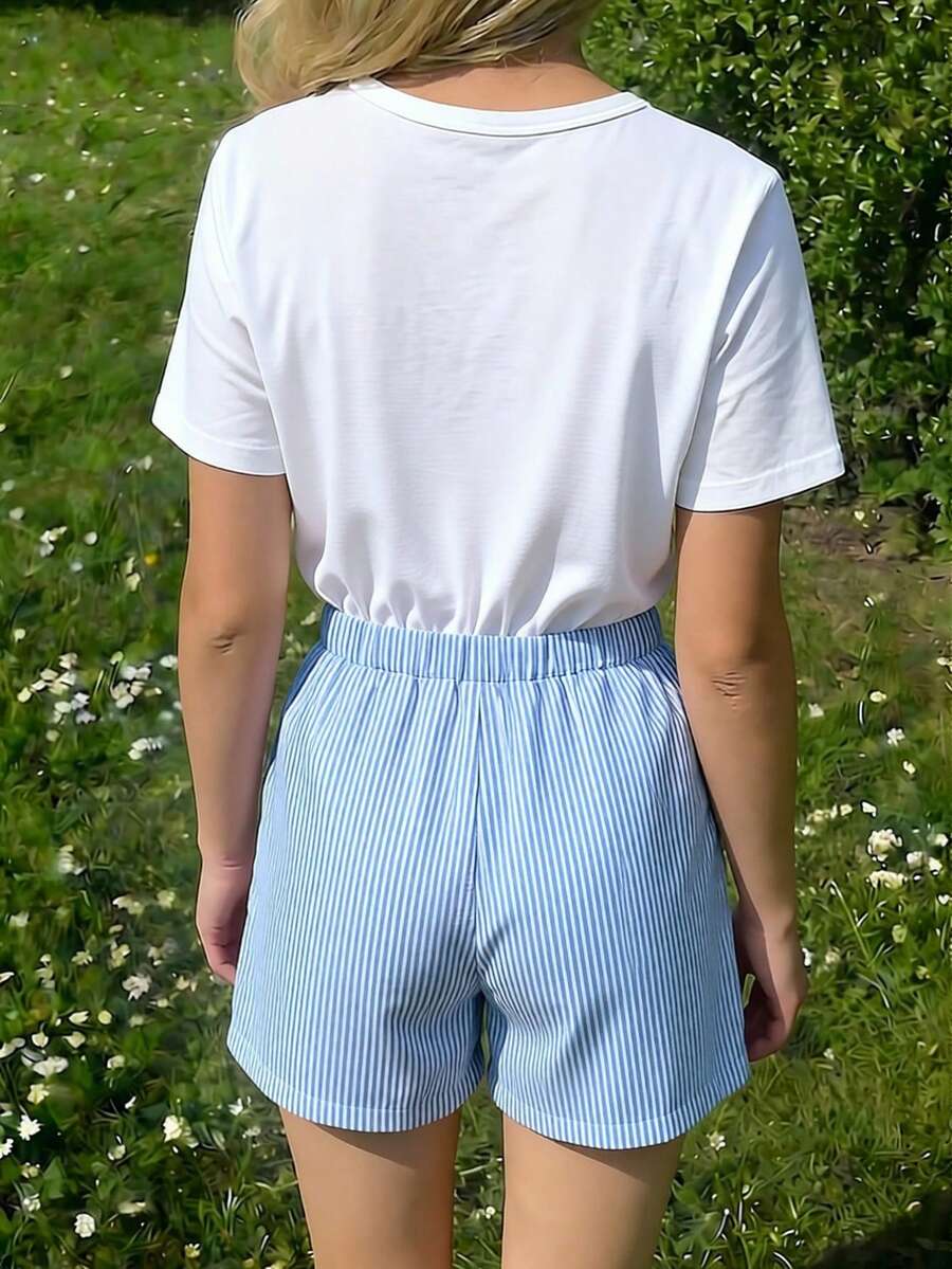 Tween girls 2-piece blue outfit featuring a short sleeve round neck t-shirt with a bow front detail and an asymmetric wrap skort.
