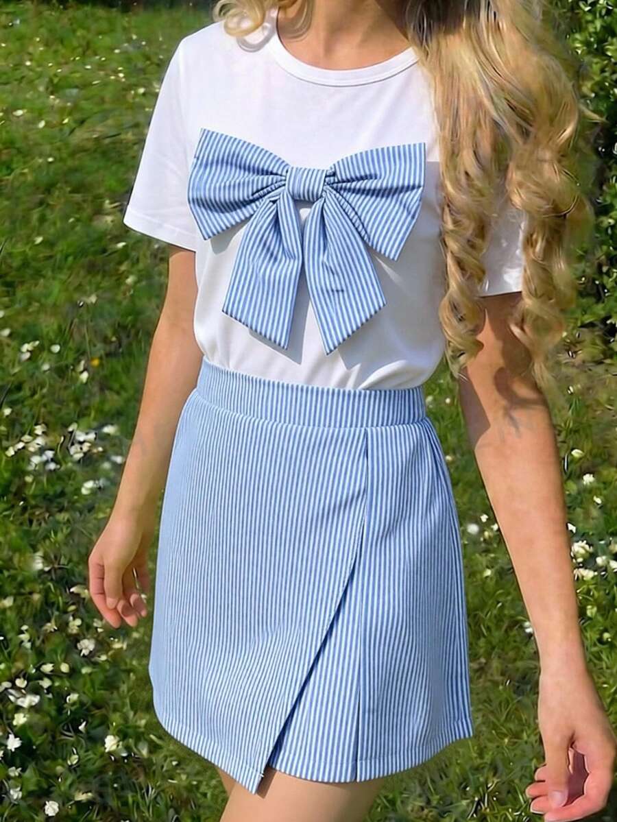 Tween girls 2-piece blue outfit featuring a short sleeve round neck t-shirt with a bow front detail and an asymmetric wrap skort.