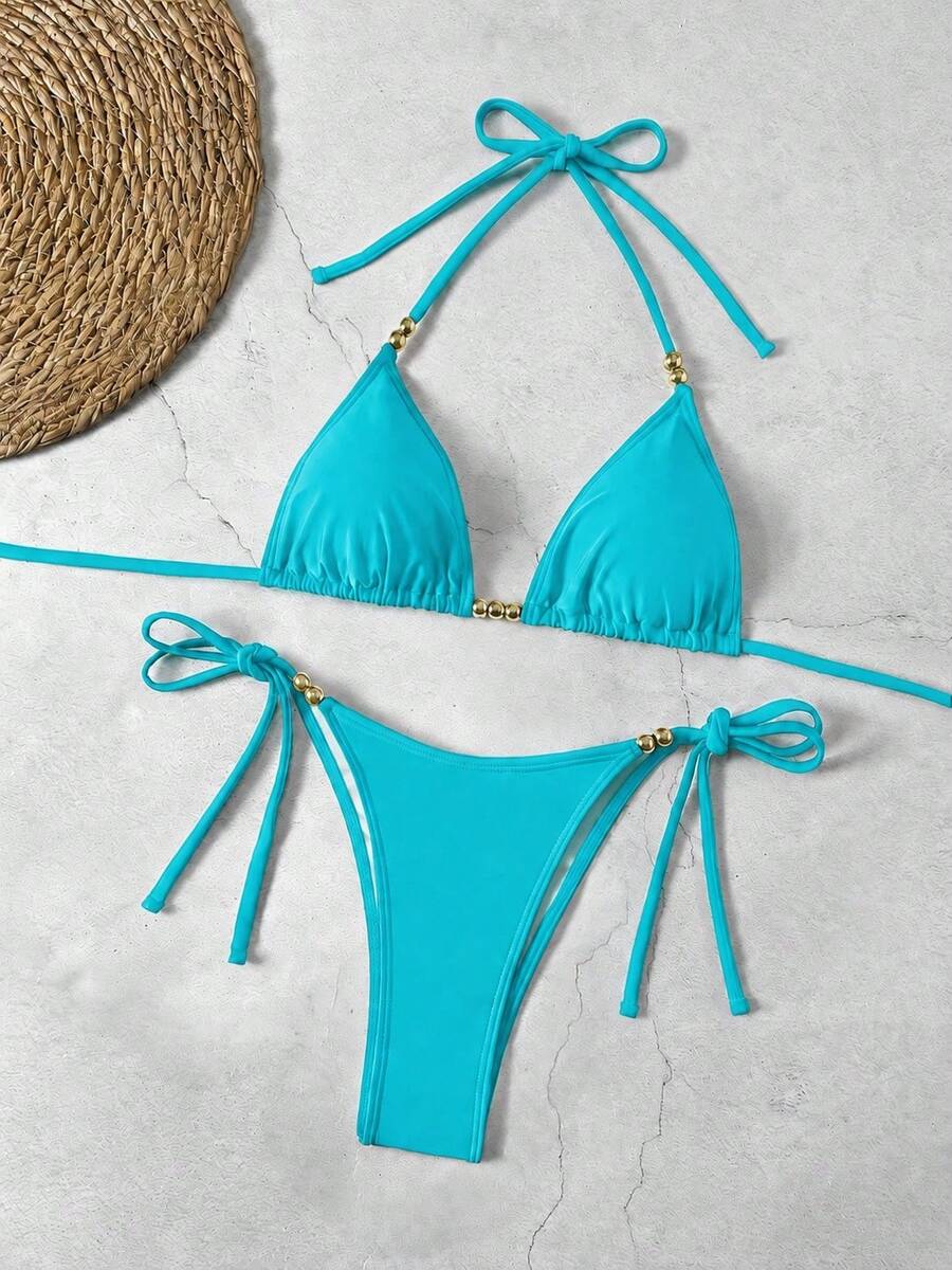 Women's black halter bikini set featuring triangle cups with gold bead decor and tie-back closure