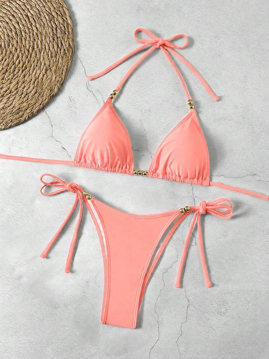 Women's black halter bikini set featuring triangle cups with gold bead decor and tie-back closure