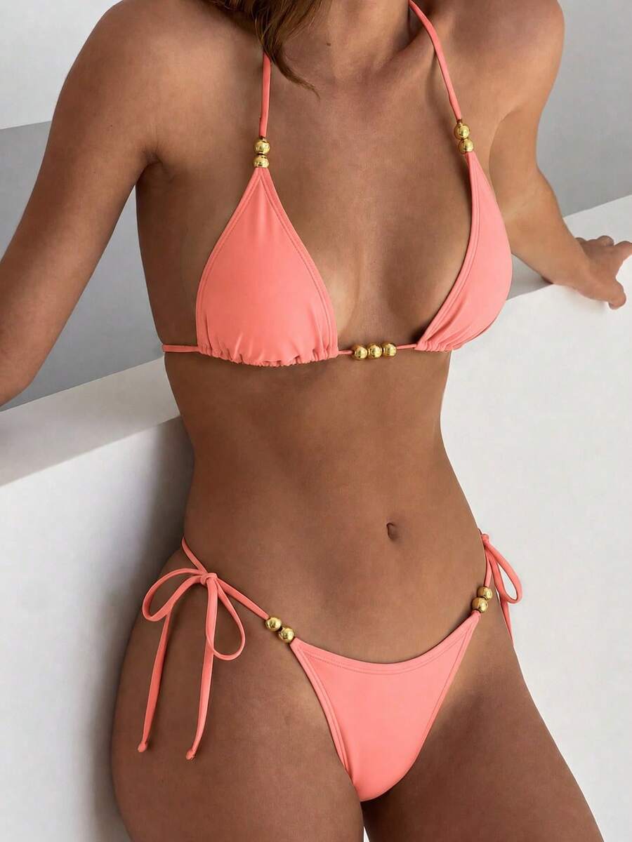 Women's black halter bikini set featuring triangle cups with gold bead decor and tie-back closure