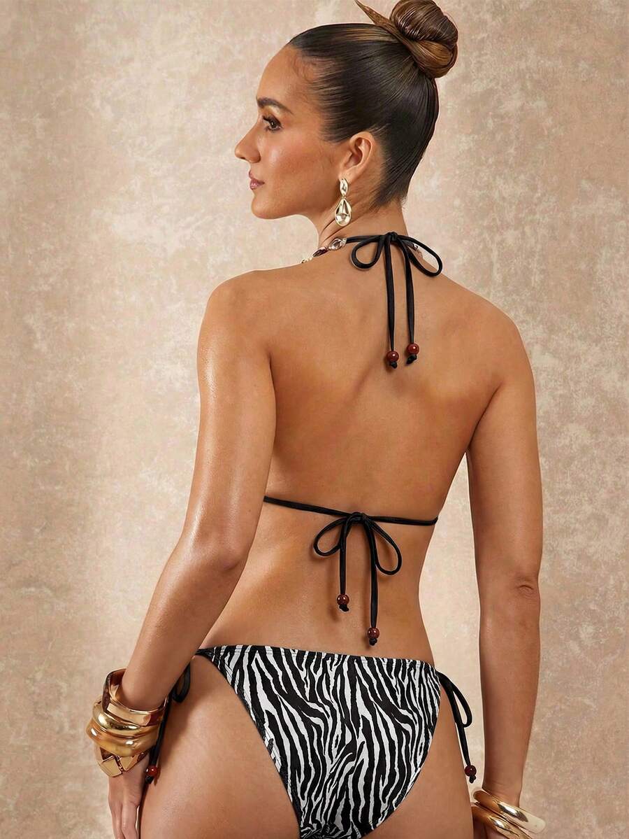 Women's black and white halter triangle bikini top and high waist tie side thong bottoms set.