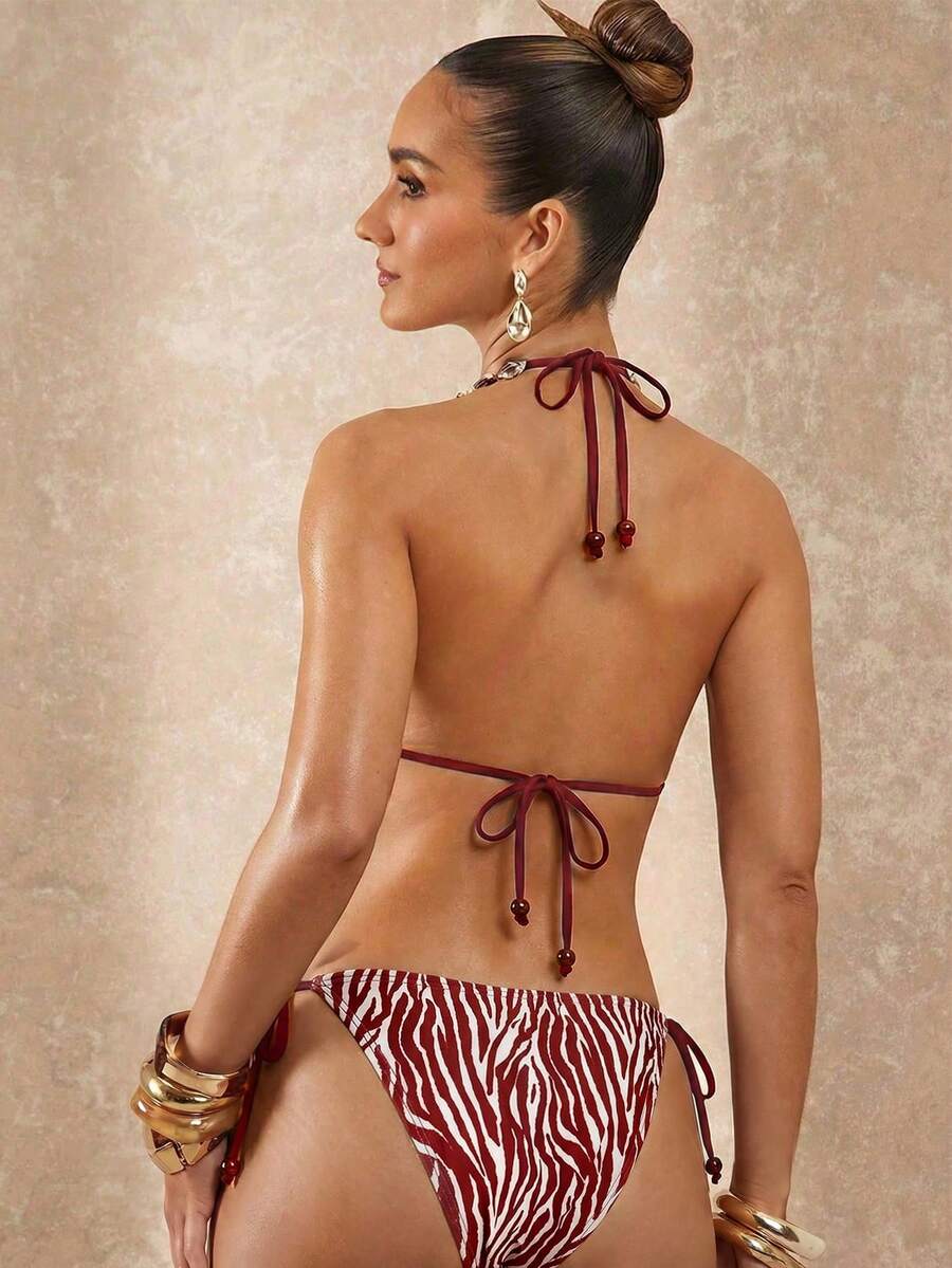 Women's black and white halter triangle bikini top and high waist tie side thong bottoms set.