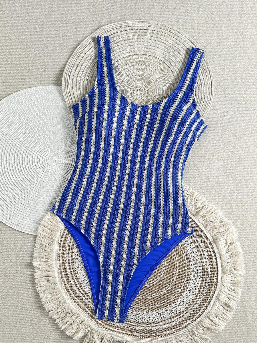 Women's solid color one-piece swimsuit featuring a backless scoop neck design and high cut fit