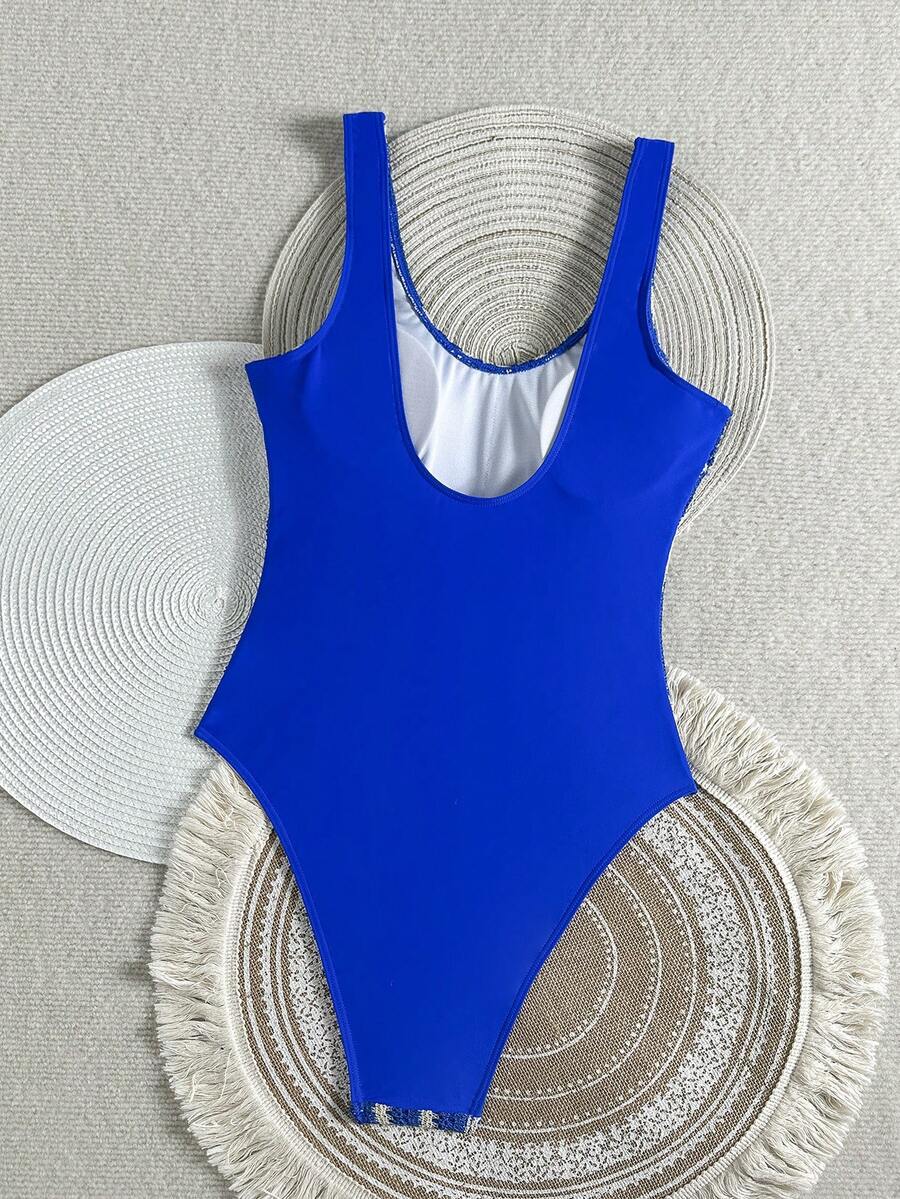 Women's solid color one-piece swimsuit featuring a backless scoop neck design and high cut fit