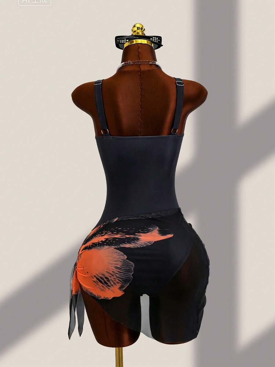 Women's black floral print plunge neck one-piece swimsuit featuring cut-out detail paired with a matching knee-length mesh cover-up skirt