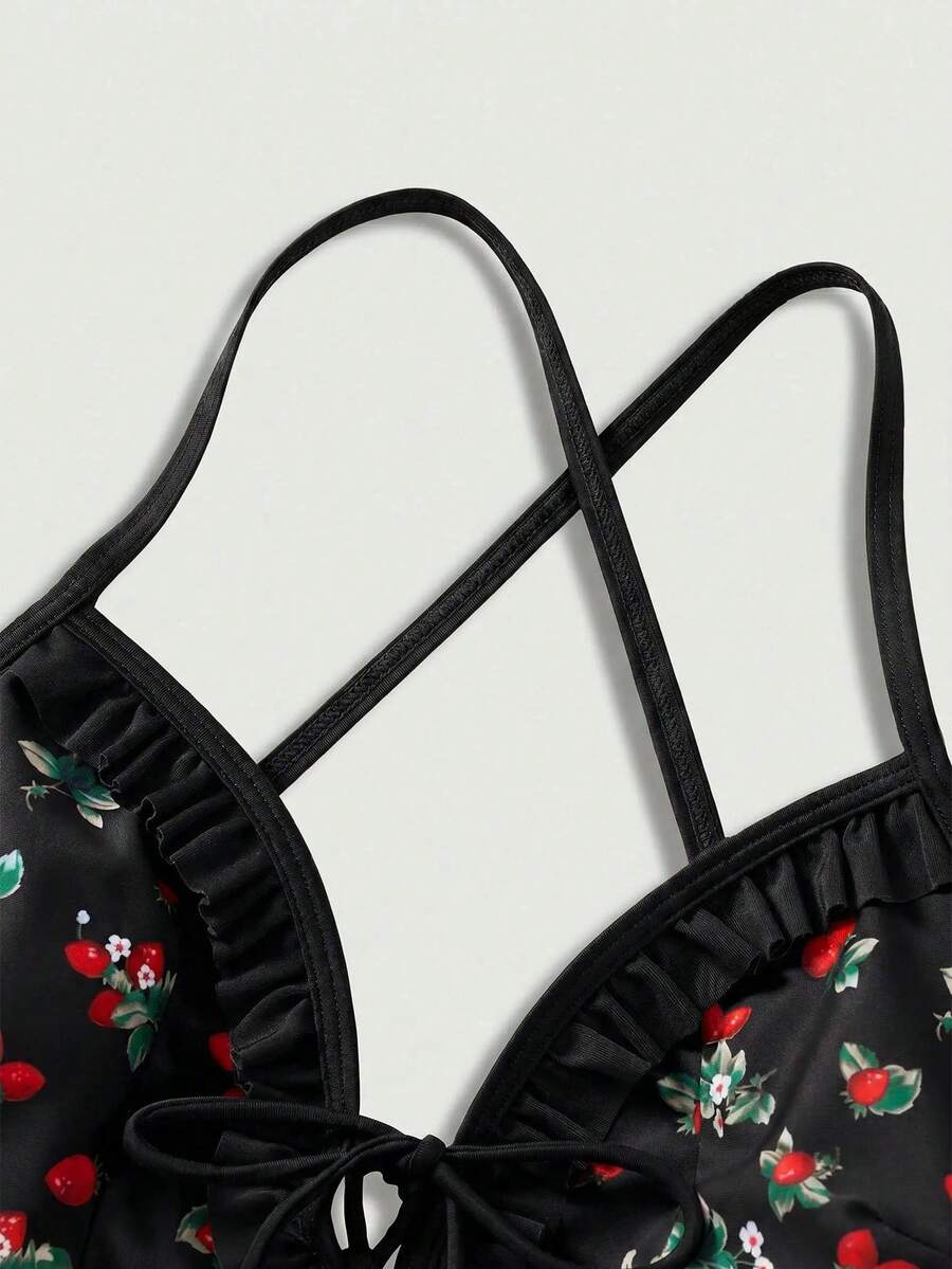 Women's strawberry print one-piece swimsuit featuring ruffle details, front-tie design, backless criss-cross straps, and triangle wireless cups.