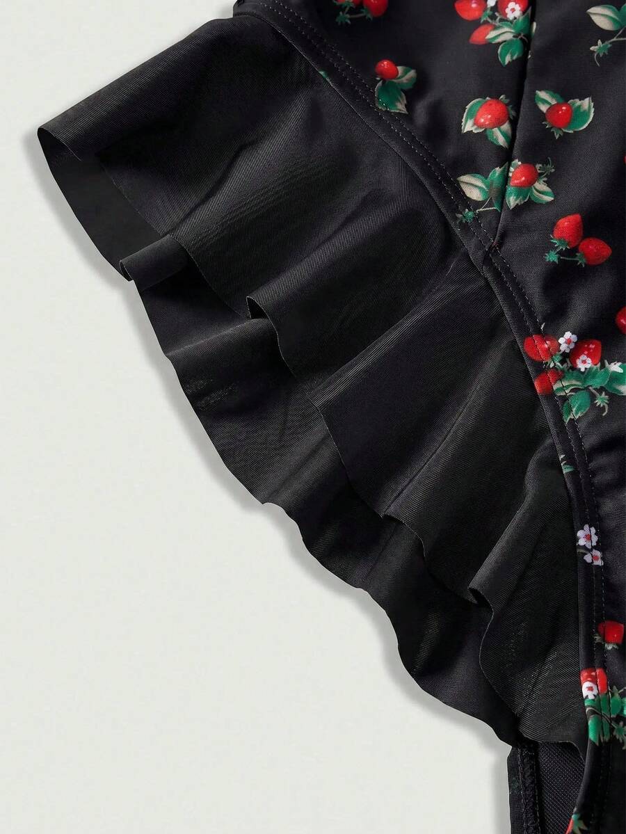 Women's strawberry print one-piece swimsuit featuring ruffle details, front-tie design, backless criss-cross straps, and triangle wireless cups.
