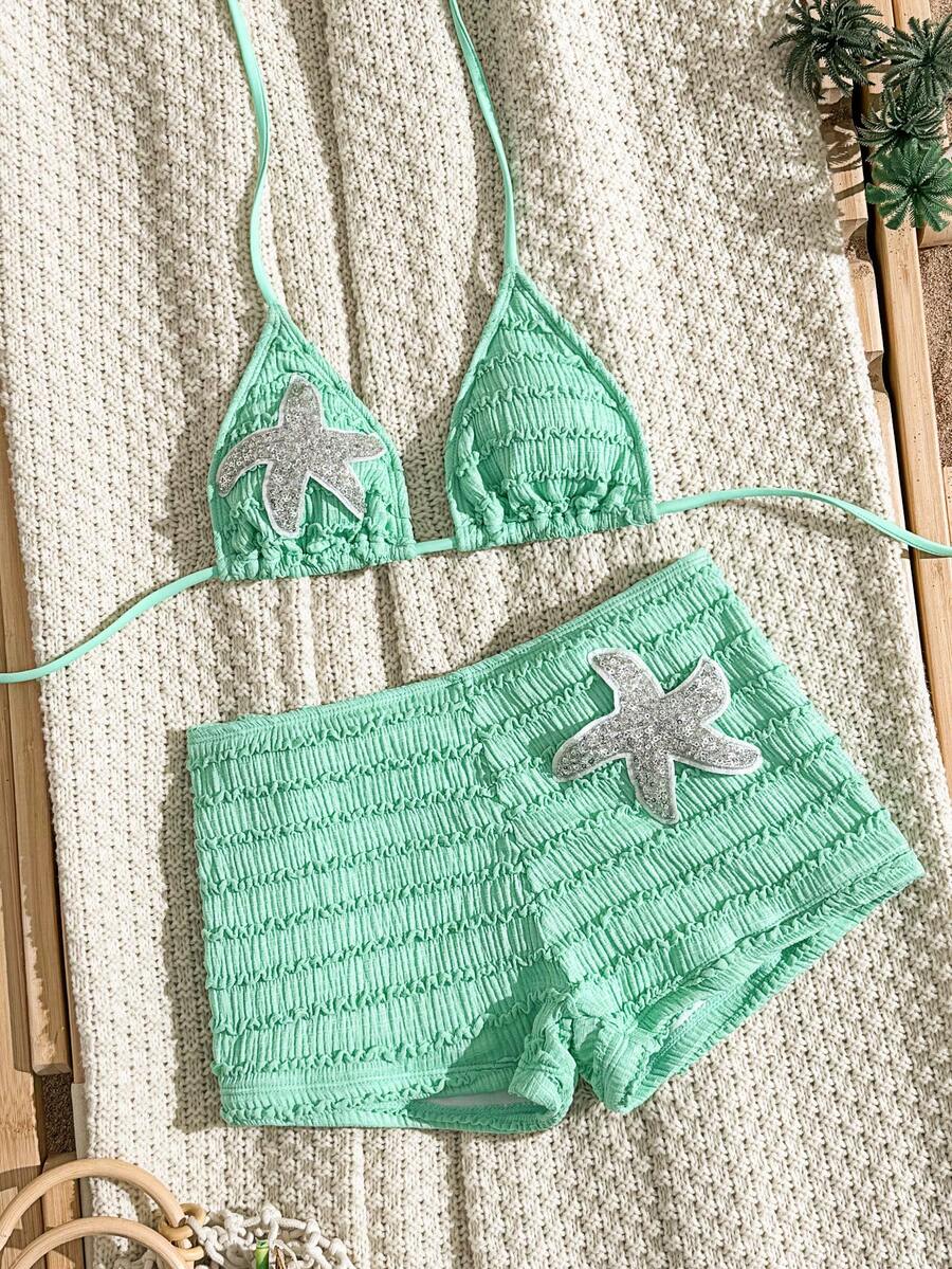 Women's apricot two-piece swimsuit set with a halter tie-back top and matching high stretch shorts.