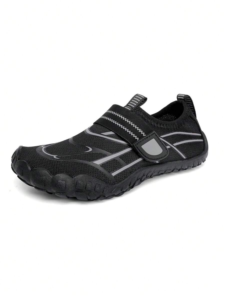 Black kids water shoes with graphic pattern, fabric upper, hook and loop closure, and non-slip rubber outsole for boys and girls.