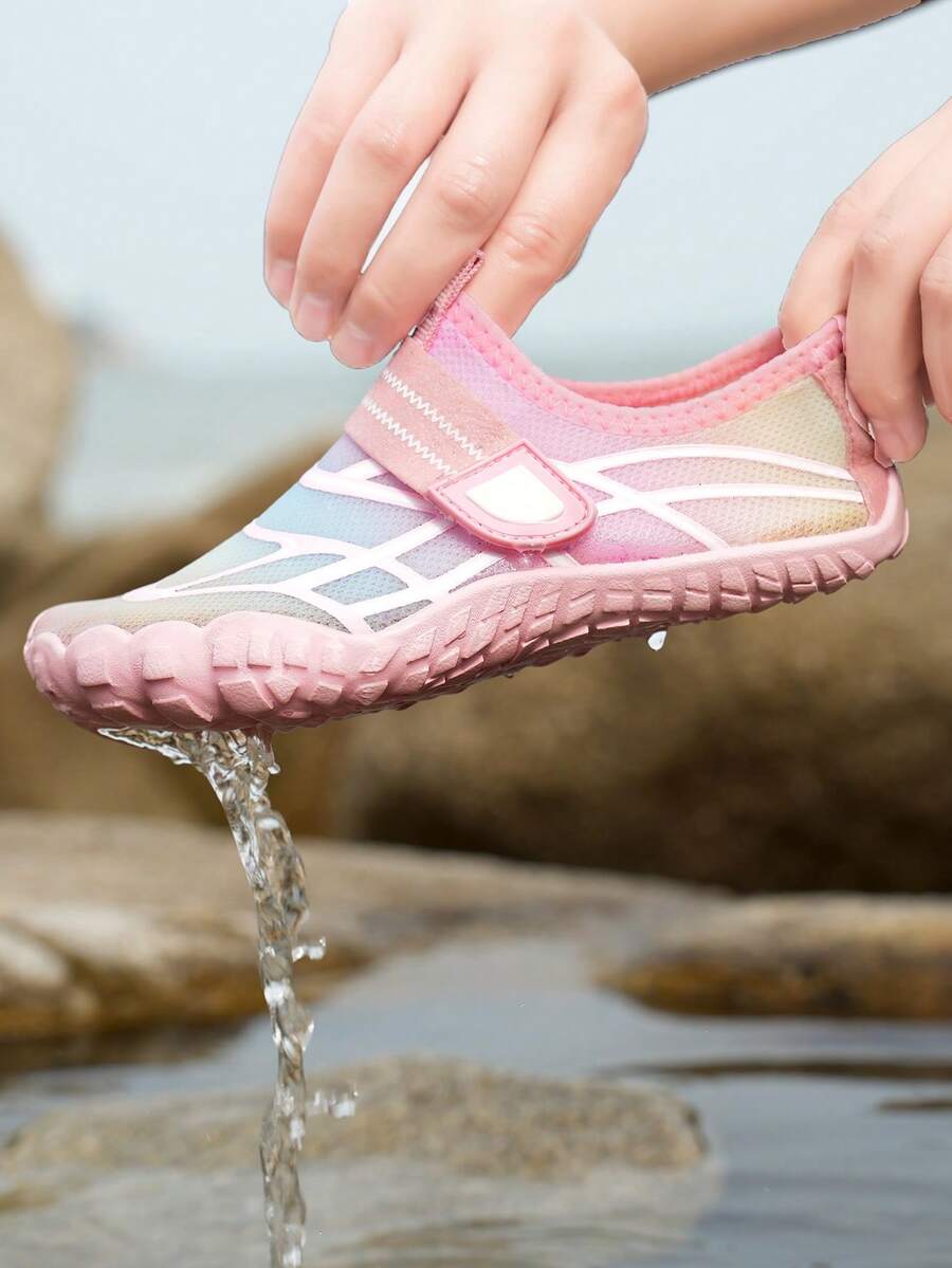 Black kids water shoes with graphic pattern, fabric upper, hook and loop closure, and non-slip rubber outsole for boys and girls.